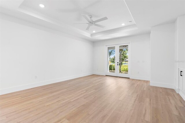 4190 Rossmore Dr, Orlando, FL 32810 - spare room featuring a raised ceiling, light wood-type flooring, french doors, recessed lighting, and ceiling fan