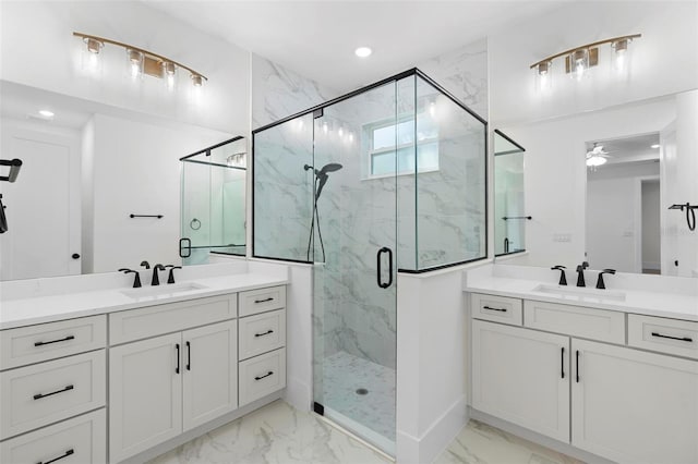 bathroom featuring a shower with door, ceiling fan, and vanity