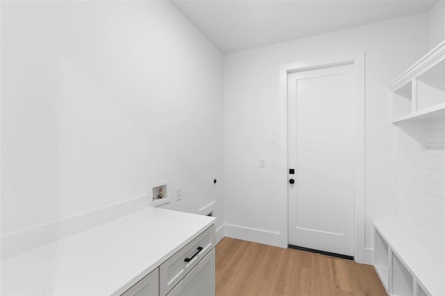 laundry room with light hardwood / wood-style flooring, electric dryer hookup, cabinets, and hookup for a washing machine