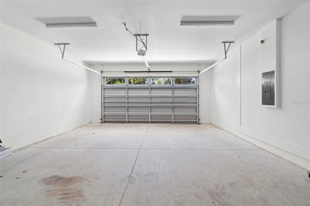 4190 Rossmore Dr, Orlando, FL 32810 - garage with electric panel and a garage door opener