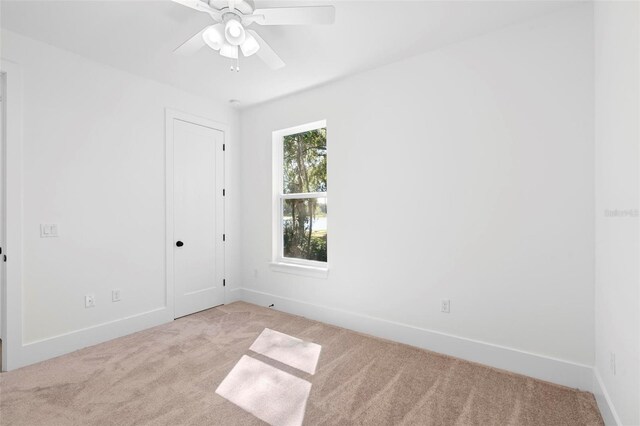4190 Rossmore Dr, Orlando, FL 32810 - unfurnished room featuring light colored carpet, baseboards, and a ceiling fan