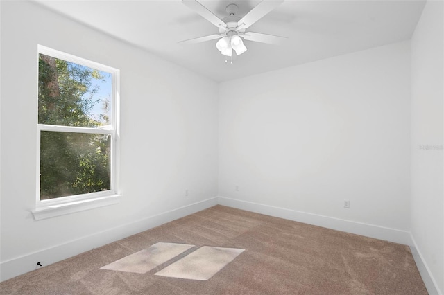 carpeted empty room featuring ceiling fan