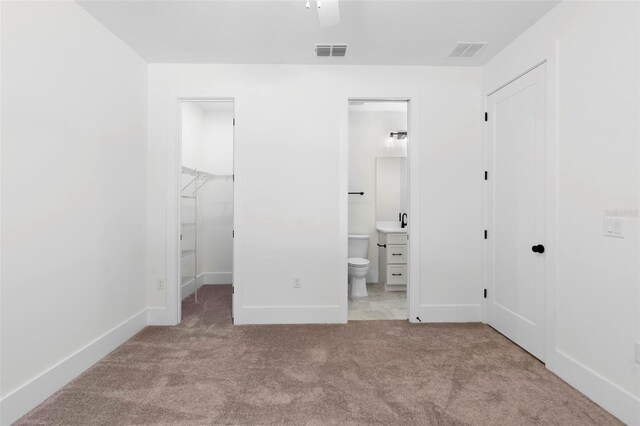 4190 Rossmore Dr, Orlando, FL 32810 - unfurnished bedroom featuring a closet, carpet floors, baseboards, ensuite bath, and a spacious closet