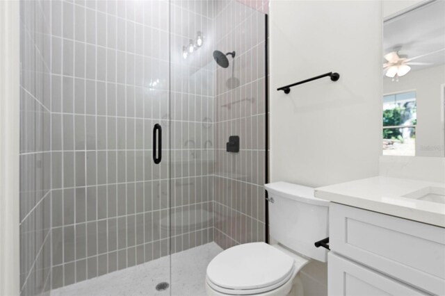 4190 Rossmore Dr, Orlando, FL 32810 - bathroom with a stall shower, vanity, toilet, and a ceiling fan