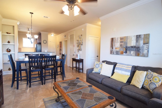 tiled living room with ceiling fan, ornamental molding, and built in shelves