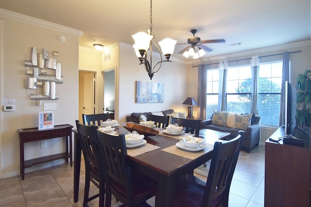 dining room featuring crown molding, ceiling fan with notable chandelier, and tile patterned flooring