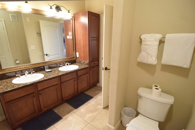 bathroom with vanity, toilet, and tile patterned flooring