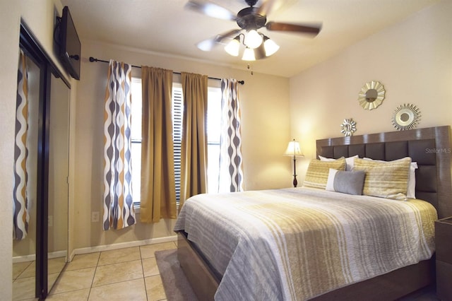 tiled bedroom featuring ceiling fan