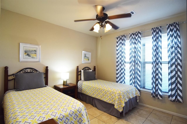 tiled bedroom featuring ceiling fan