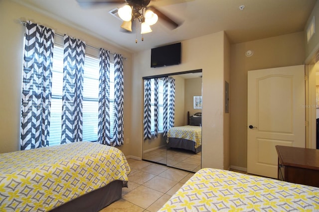 bedroom featuring a closet, tile patterned flooring, and ceiling fan