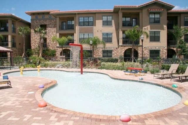 view of pool with a patio area and pool water feature