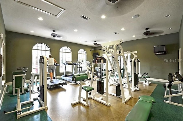 workout area with a textured ceiling and ceiling fan