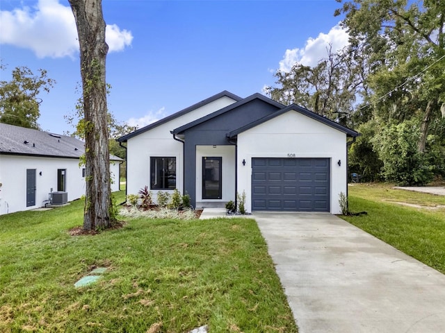 view of front of house with cooling unit, a garage, and a front lawn