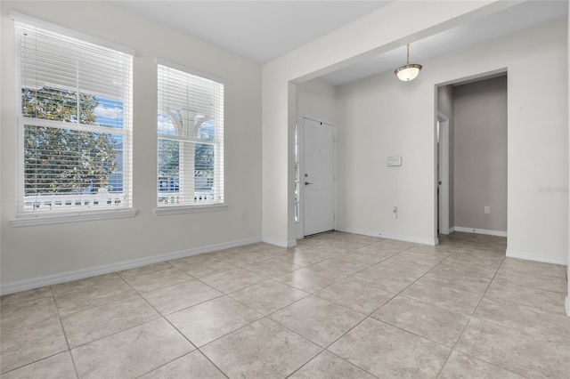 empty room with light tile patterned flooring