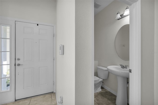 bathroom with tile patterned flooring, toilet, and sink