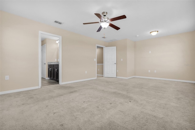 empty room featuring light carpet and ceiling fan