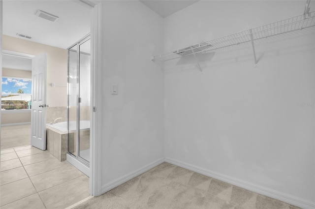 walk in closet featuring light tile patterned floors