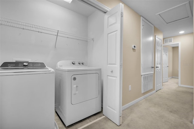 laundry room featuring light carpet and washing machine and clothes dryer