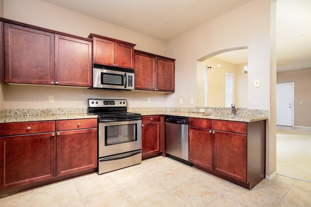 kitchen featuring light stone countertops and appliances with stainless steel finishes