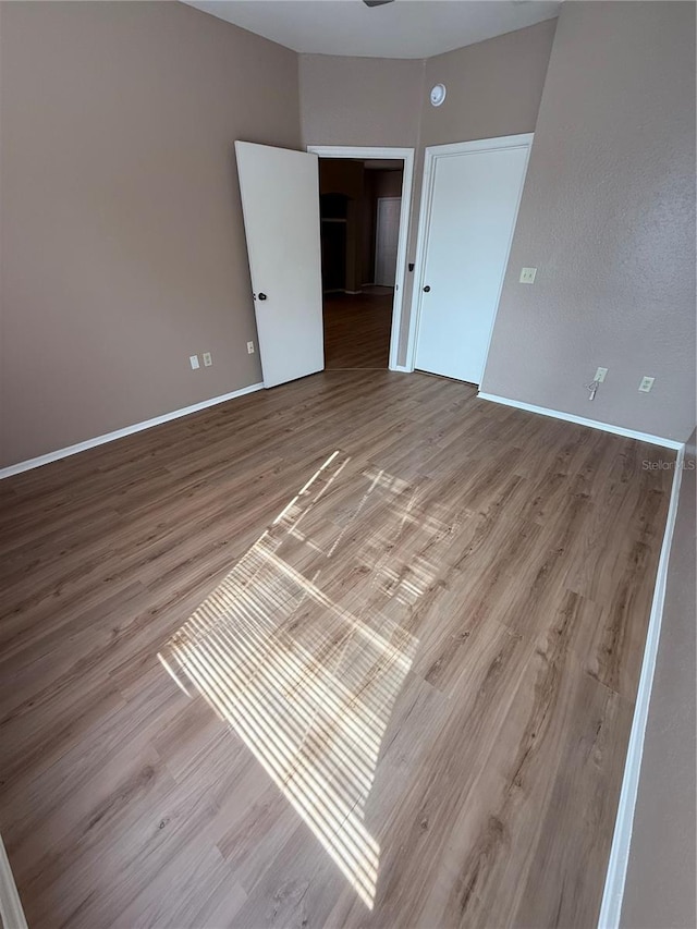 unfurnished room with light wood-type flooring