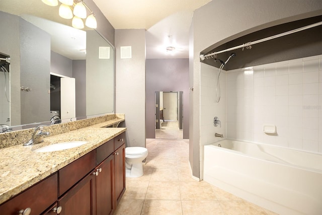 full bathroom with tile patterned flooring, vanity, washtub / shower combination, and toilet