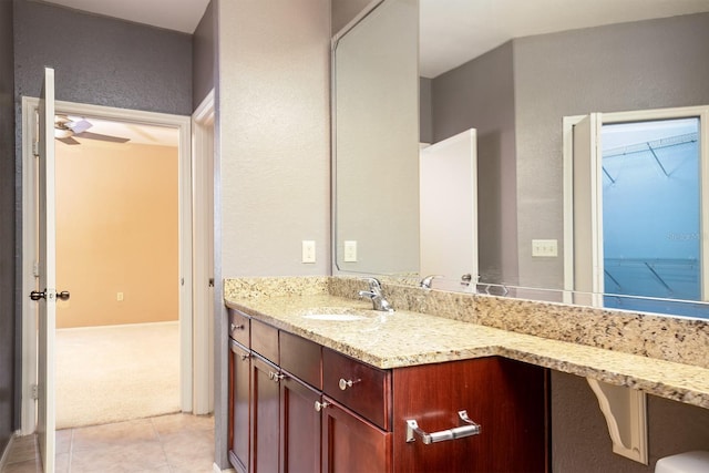 bathroom featuring tile patterned flooring, vanity, and ceiling fan