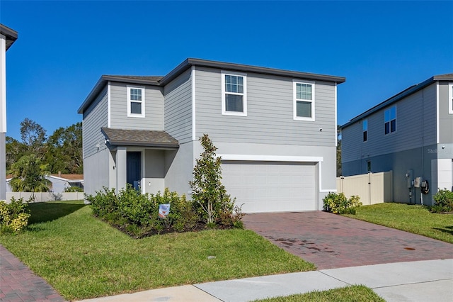 view of front facade with a front yard and a garage