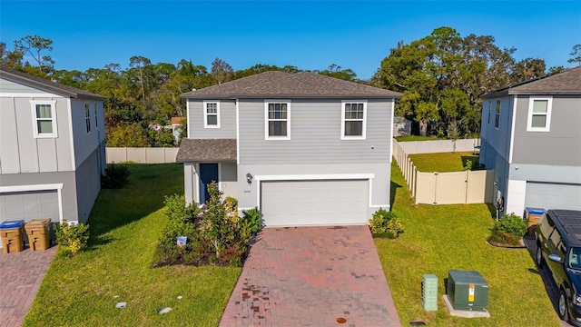 view of front facade with a front yard and a garage