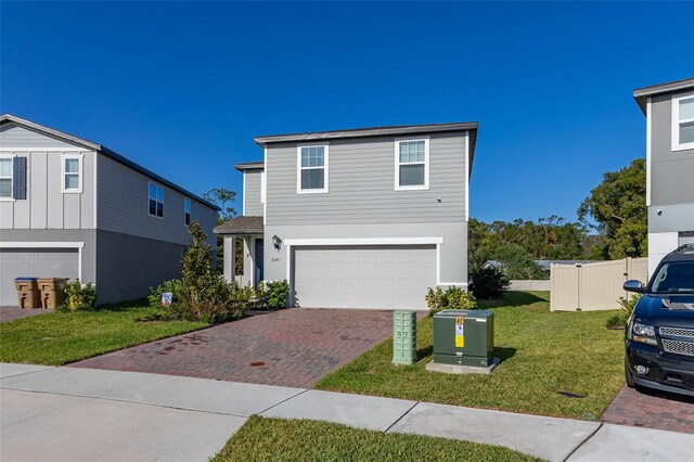 view of front property with a front yard and a garage