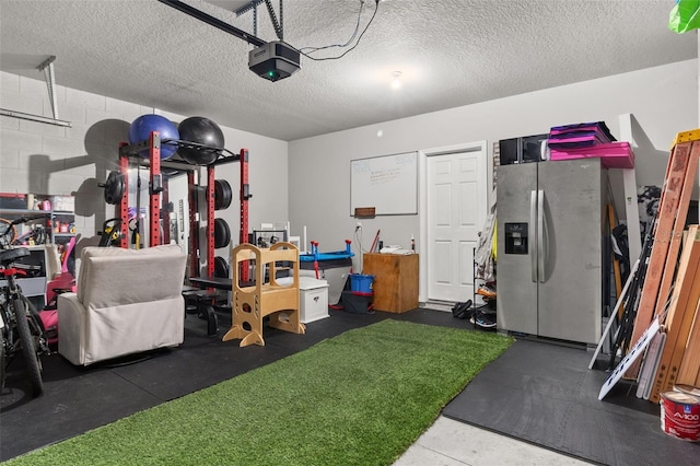 garage with a garage door opener and stainless steel fridge