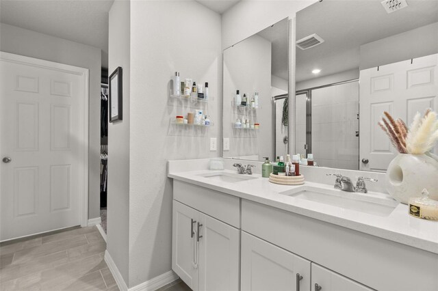 bathroom featuring vanity and a shower with shower door