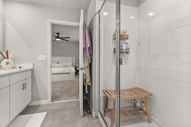 bathroom featuring vanity, tile patterned floors, a shower with shower door, and ceiling fan