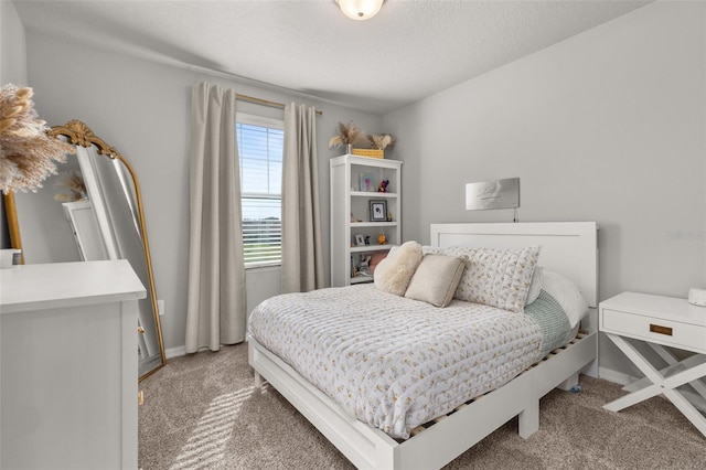 bedroom featuring a textured ceiling and carpet