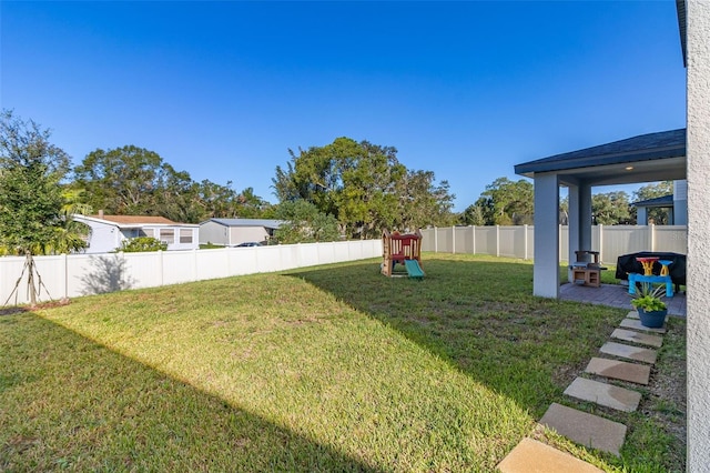 view of yard featuring a patio area and a playground