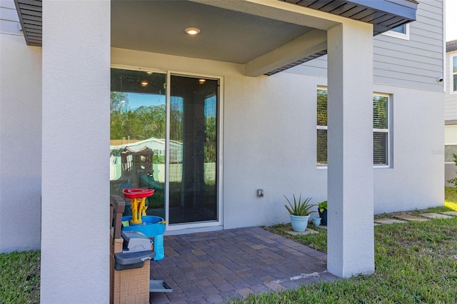 doorway to property with a patio