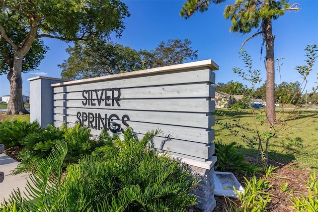 community sign featuring a lawn