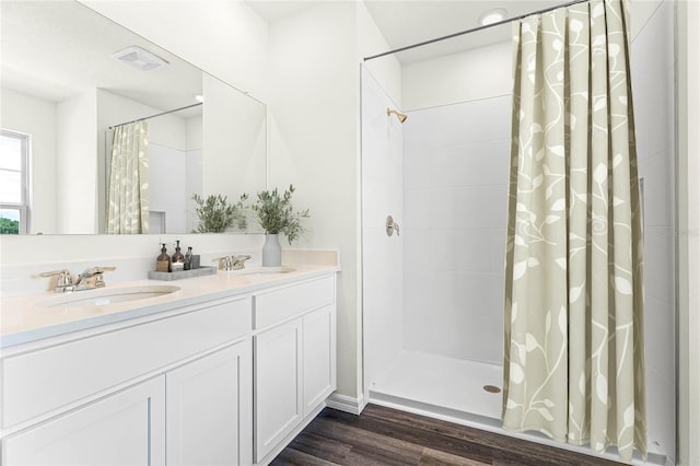 bathroom with a shower with shower curtain, vanity, and hardwood / wood-style floors