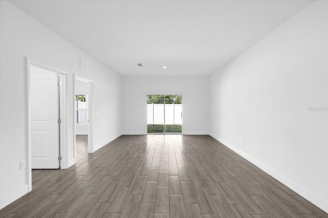 unfurnished room featuring dark hardwood / wood-style flooring