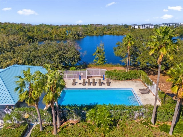 view of swimming pool with a water view and a patio area