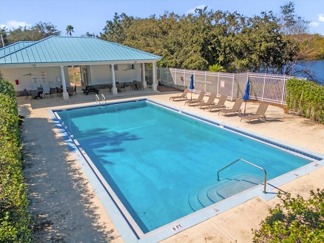 view of pool with a patio and ceiling fan