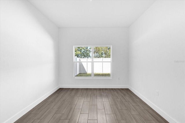 spare room with wood-type flooring