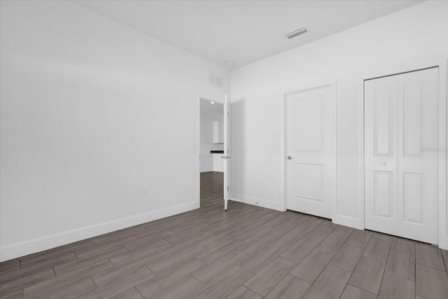 unfurnished bedroom with hardwood / wood-style flooring