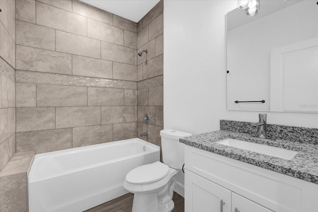 full bathroom with vanity, tiled shower / bath combo, wood-type flooring, and toilet