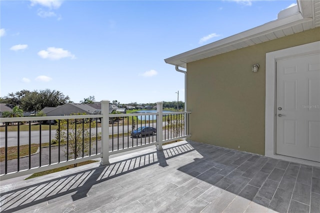 exterior space featuring a balcony and a water view