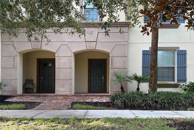 9033 Rhodes St, Kissimmee, FL 34747 - view of exterior entry featuring stucco siding