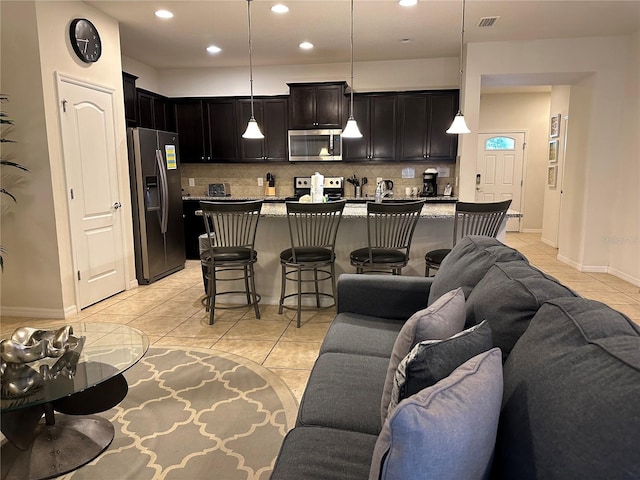9033 Rhodes St, Kissimmee, FL 34747 - living area featuring light tile patterned floors and recessed lighting