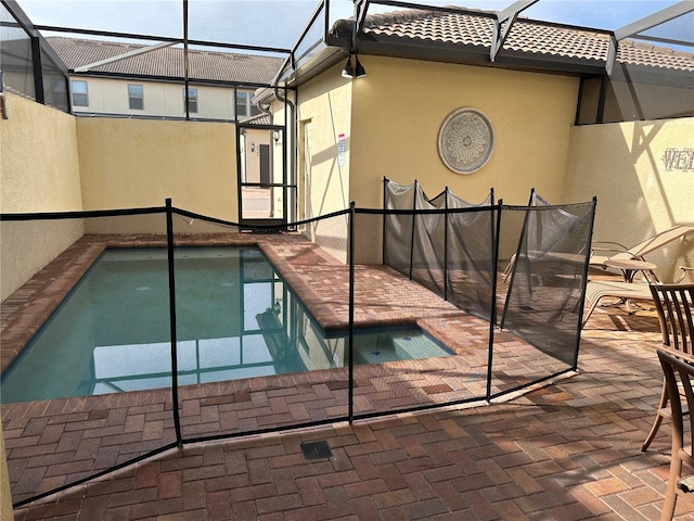 view of pool featuring a patio area and glass enclosure