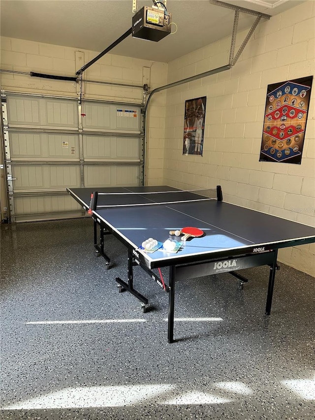 9033 Rhodes St, Kissimmee, FL 34747 - game room with a garage, concrete block wall, and speckled floor