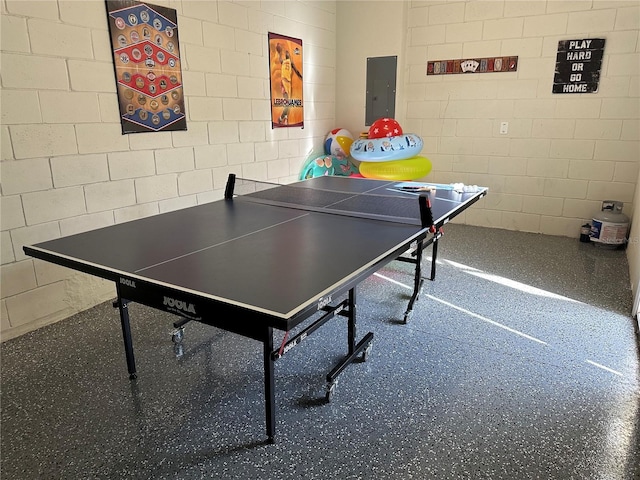 9033 Rhodes St, Kissimmee, FL 34747 - playroom with concrete block wall, electric panel, and speckle patterned floor