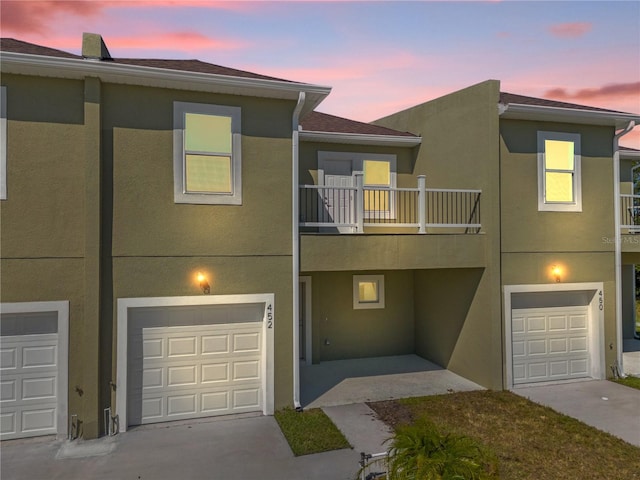 view of property featuring a balcony and a garage